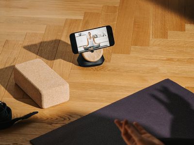 Yoga blocks and a mat on a wooden floor.